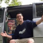 Marshall standing in the doorway of his minivan camper van life conversion Carol the Caravan