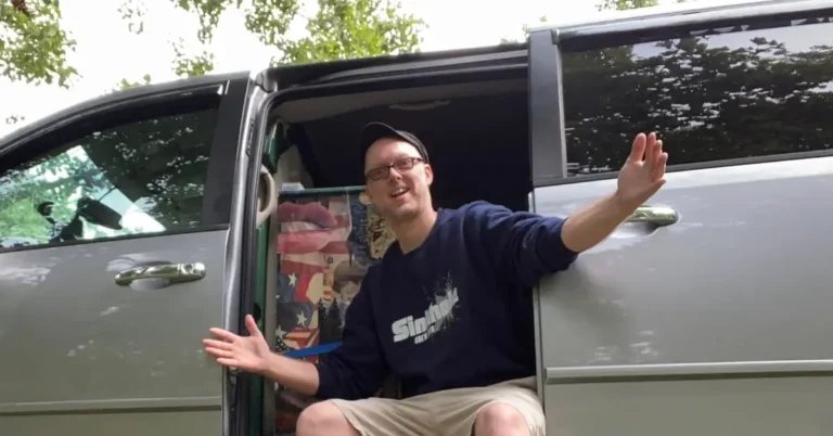 Marshall standing in the doorway of his minivan camper van life conversion Carol the Caravan